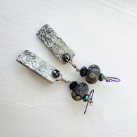 Iridescent and black lampwork earrings feature jasper dangles