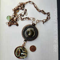 One of a kind artisan necklace is mixed media with copper, lampwork and ceramic