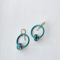 colorful earrings in teal and chartreuse feature lampwork and anodized aluminum