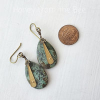 Tribal earrings feature turquoise and brass