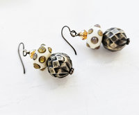 Playful artisan earrings in shades of white, yellow and grey.