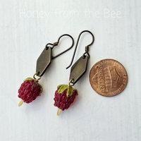 Summer earrings feature raspberry lampwork glass