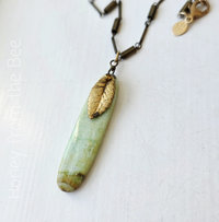 Green gemstone pendant with vintage brass leaf