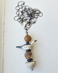 By the sea necklace features lampwork and sea pottery