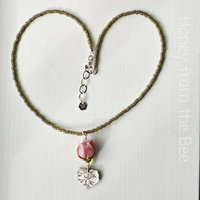 Bridesmaid necklaces feature pink rosebuds and silver leaf