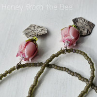 Pink rose necklace features lampworked rosebud and silver leaf dangle