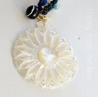 Carved Mother of Pearl pendant with lampwork and silk ribbon