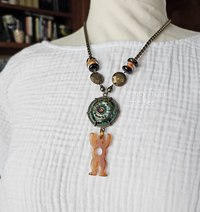 Talisman statement necklace with ceramic in green and man shaped bone charm