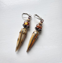 Statement earrings feature lampwork and sterling silver in orange and cream