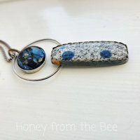 Silver and blue pendant features glass cabochon by Mikelene Reusse and a K2 granite cab