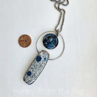 Blue and silver necklace features K2 granite and glass cabochon