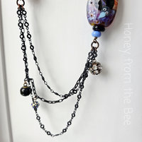 black charm chain with crow lampwork
