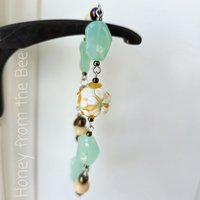Celadon and yellow bracelet with daisy lampwork bead focal