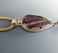 Fancy jasper cabochon has shades of burgundy, rose and pink with a splash of gold in this artisan pendant.