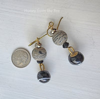 Antique button earrings also feature lampwork in black and gold