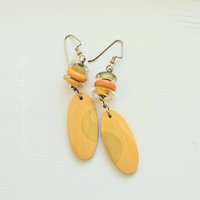 Orange artisan earrings feature lampwork and billiard ball slices