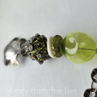 Green lampwork pendant with silver turtle
