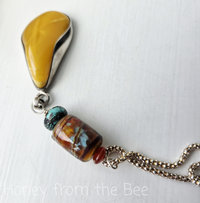 Vintage amber pendant with lampwork in turquoise and orange