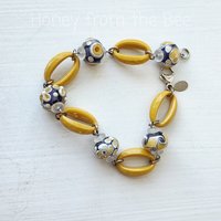 Lavender and yellow lampwork bracelet with yellow acrylic hoops