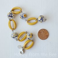 Artisan bracelet features lampwork in lavender and yellow