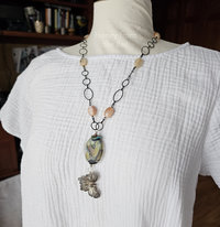 Butterfly art necklace on model.