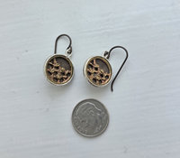 Petite button earrings feature antique brass buttons from the Victorian era