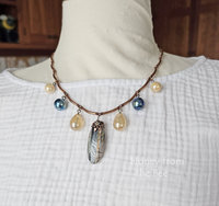 Blue and light yellow artisan necklace on model