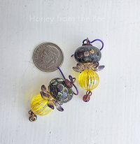 Artisan earrings feature lampwork in purple and yellow