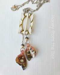 Butterfly pendant with lampworked wings and mother of pearl buckle
