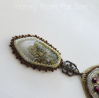 Moss Agate necklace bead embroidered in white, red and green