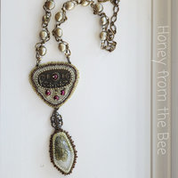 Art necklace is bead embroidered and features antique brass drawer pull and moss agate