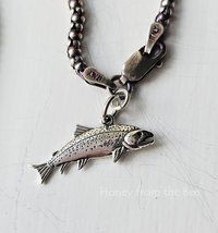 Sterling silver salmon charm represents the fish that got away.