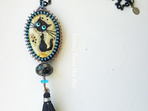 tunic length black cat pendant