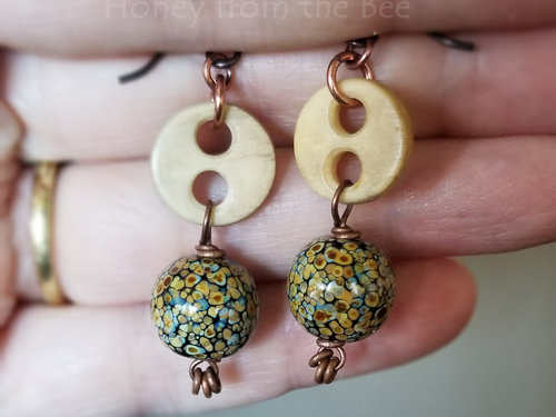 Raku lampwork earrings give off an earthy vibe