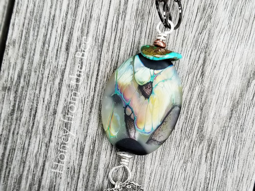 Butterfly Artisan necklace in shades of peach, green, black and silver.
