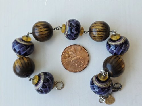 Golden brown and purple bracelet features wood beads and lampwork
