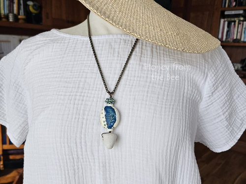 Beach wear pendant with lampwork and sea pottery on model