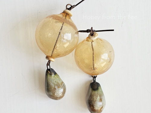 Yellow earrings feature hollow lampwork and ceramic drops