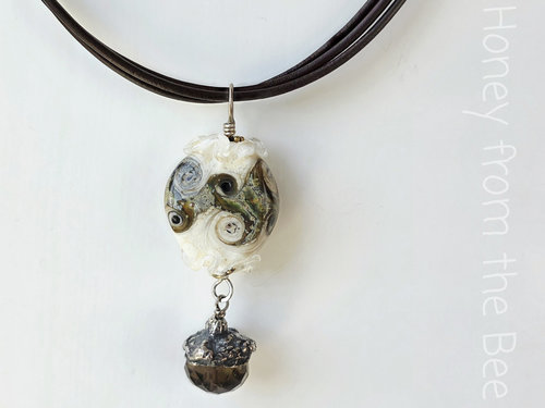 Artisan necklace features lampwork, fine silver and smokey quartz