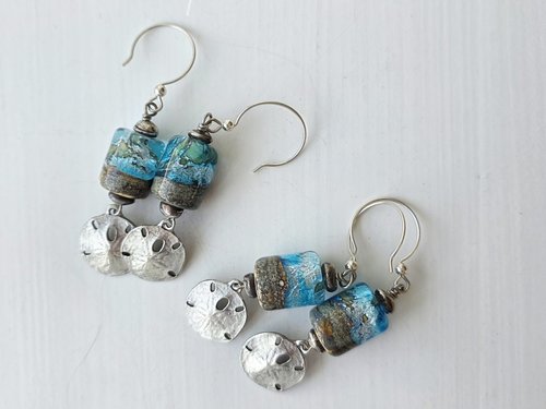 Lampwork earrings feature sand dollar charm dangles and blue and sandy lampwork
