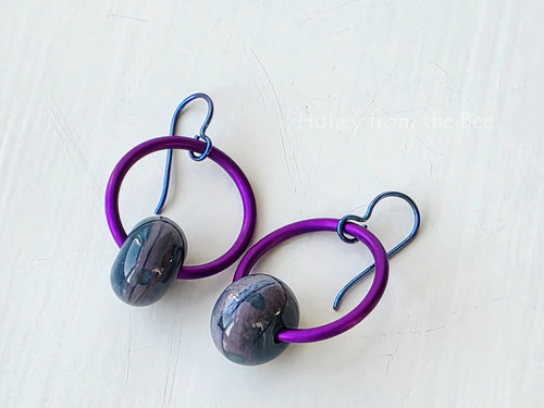Hoop earrings in purple and teal