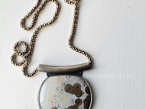 Ocean Jasper necklace in sterling silver with white background and brown orbs