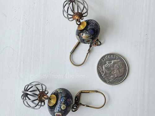 Boho style earrings feature raku lampwork with steel and brass