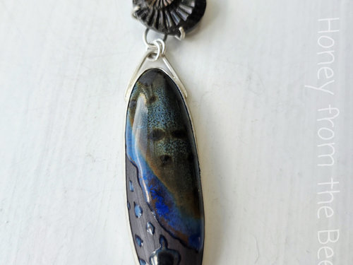 Mixed Media pendant features ceramic and ammonite set in sterling silver