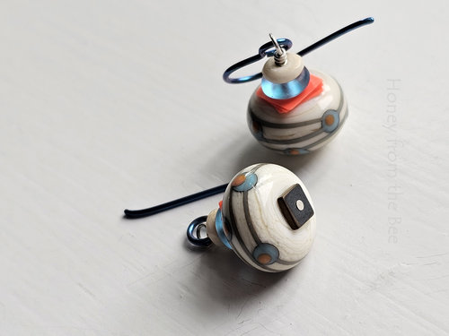 Orange and aqua earrings feature fun lampwork