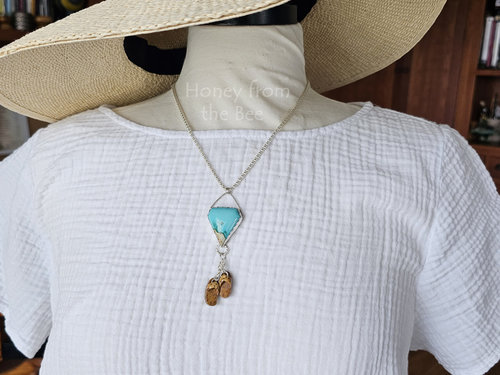 Beach inspired pendant in blue gem turquoise on model