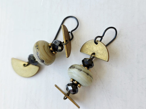 Gold and white earrings with black accents