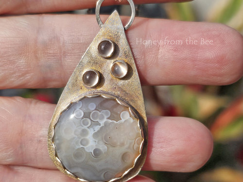 Botswana Agate and moonstone pendant set in a sterling silver teardrop