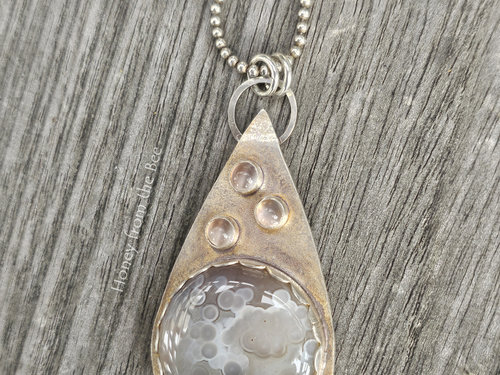Silver and taupe pendant features botswana agate and moonstones