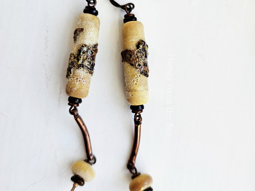 Boho style long dangle earrings in cream and copper.